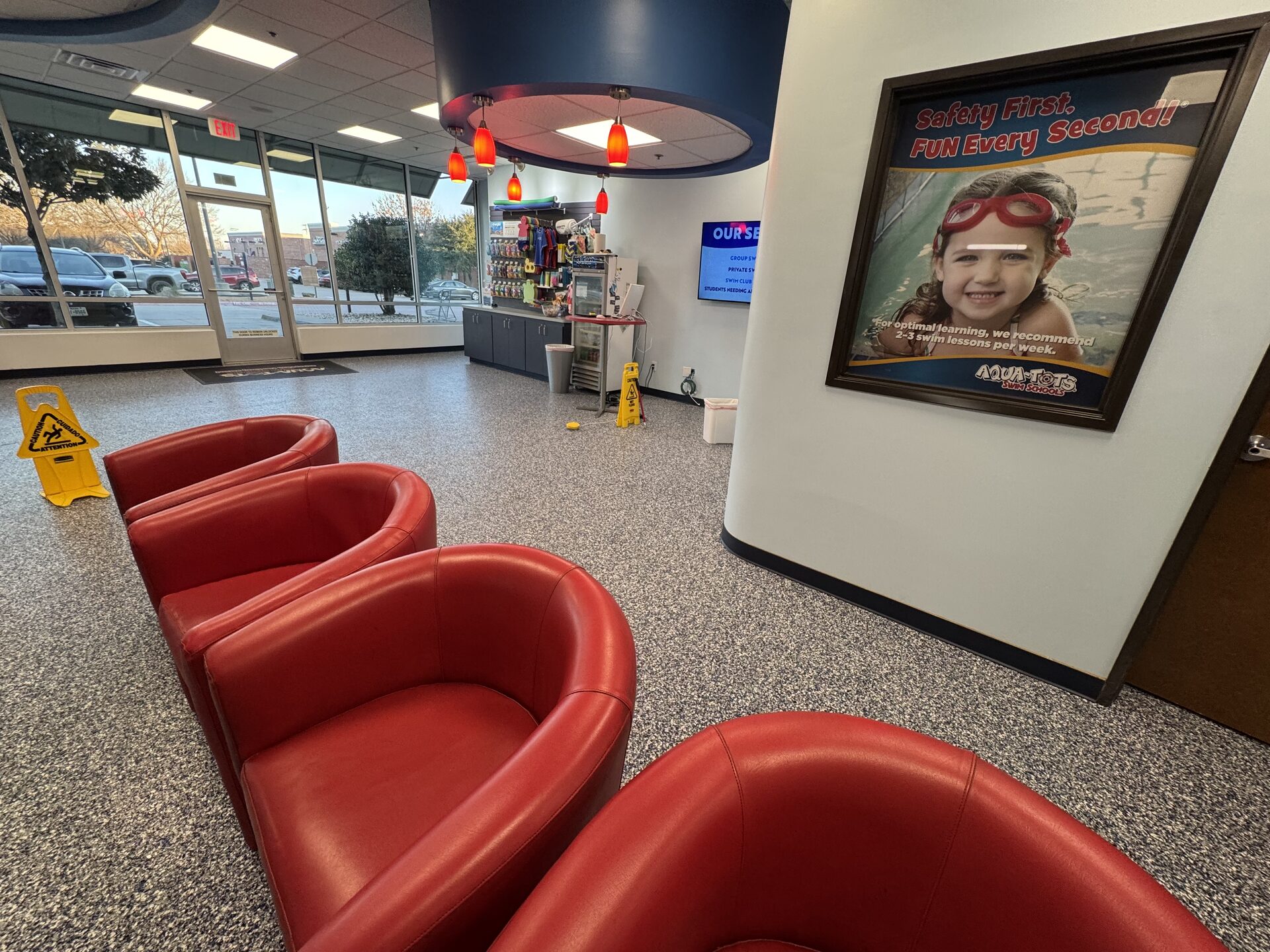 Finished custom ombre polyurea polyaspartic flake floor with anti-slip additive in a children's swim school lobby by Legacy Industrial Coatings