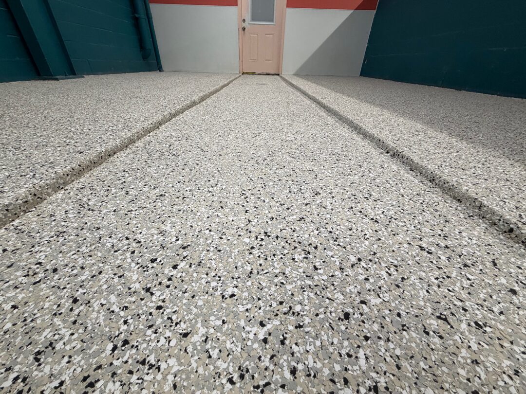 Finished polyurea polyaspartic flake floor in a Plano, TX dog training and grooming facility by Legacy Industrial Coatings