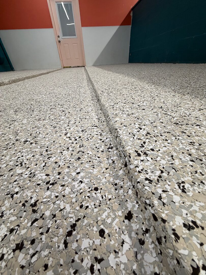 Finished dog grooming facility floor with seamless polyurea polyaspartic flake coating built for accidents and spills