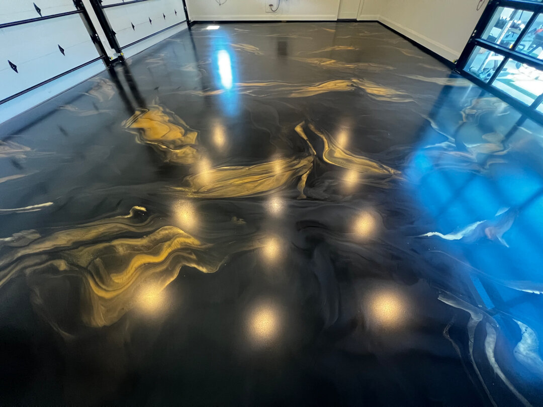 Wide view of finished metallic garage floor in Argyle TX luxury home — the floor the homeowner originally paid for, finally done right