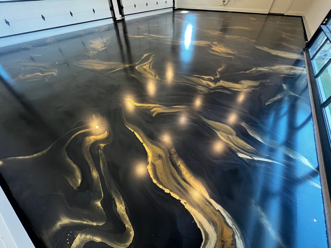 Completed luxury home garage with sealed, bonded, high-performance metallic epoxy floor by Legacy Industrial Coatings