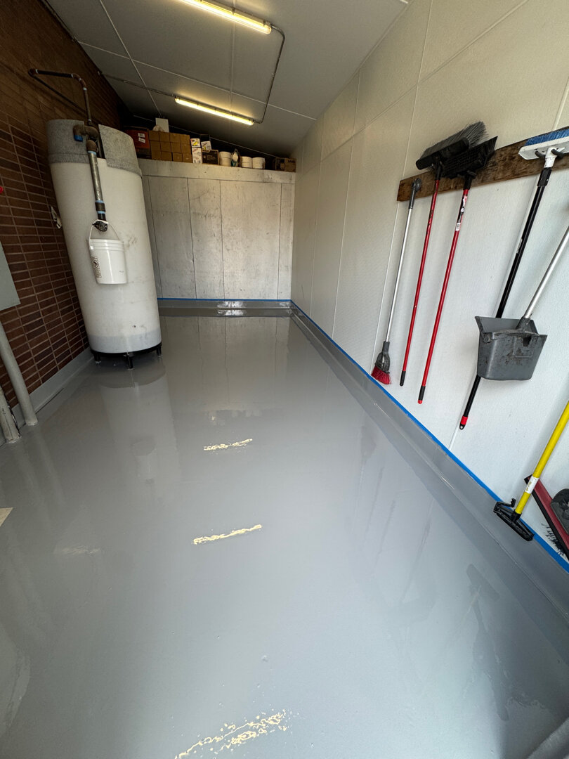 Completed restaurant pump room floor system with integrated epoxy cove base built for daily wash-down cleaning