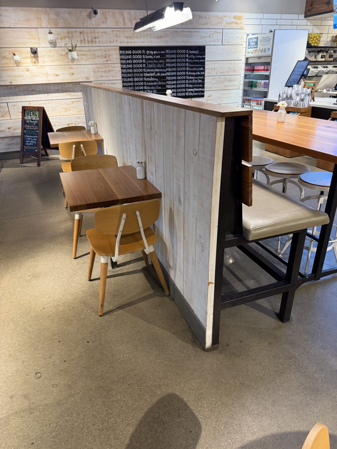 Worn fast-casual restaurant concrete floor before sealing — visible staining and dulling from 8-year-old failed sealant