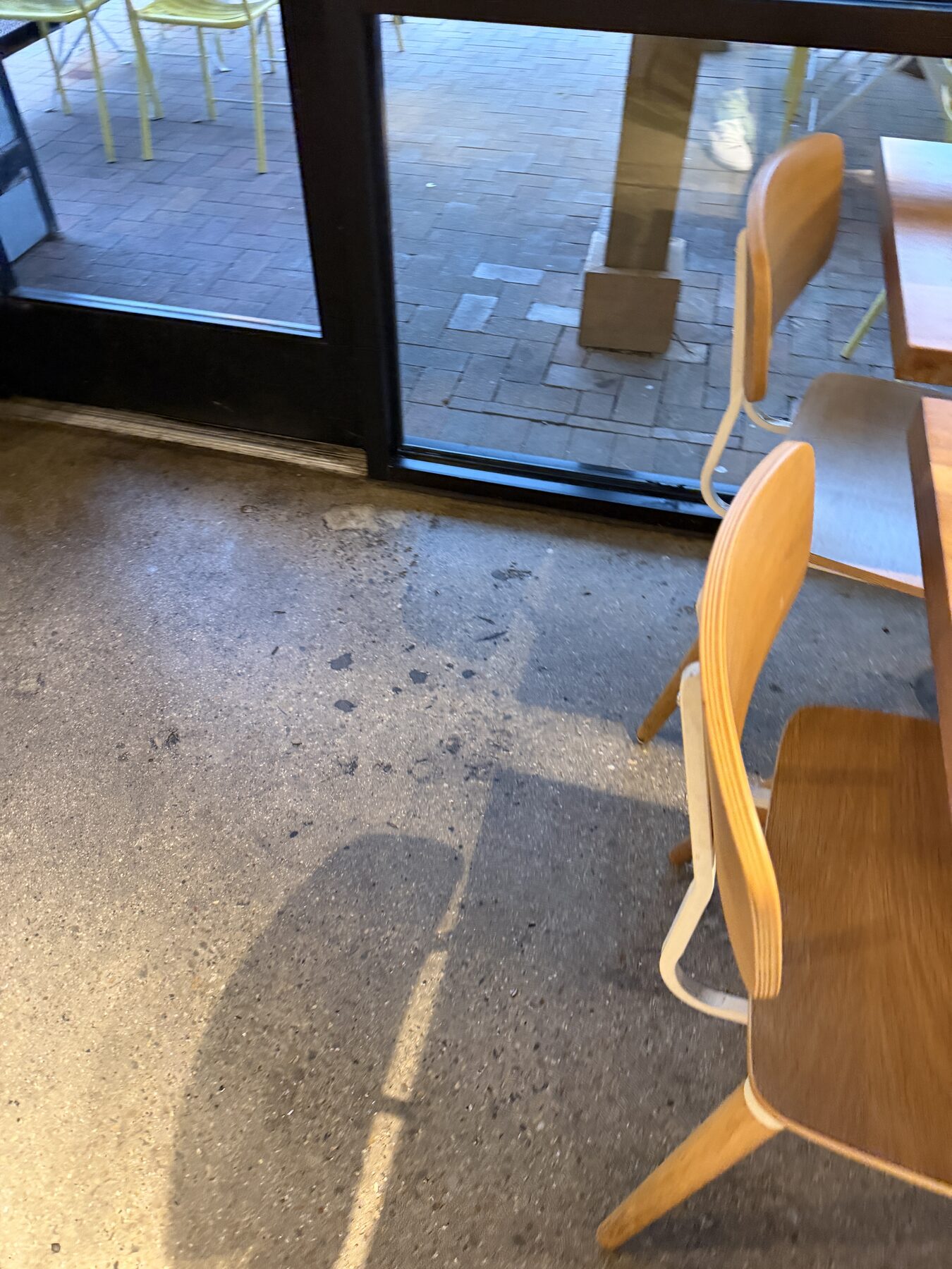 Concrete floor near service counter with embedded dirt and grime before deep cleaning