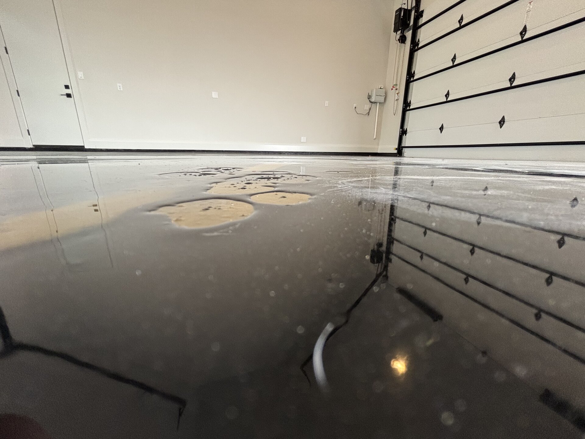 Failed metallic garage floor coming up in sheets due to no diamond grind and wrong materials used during original install