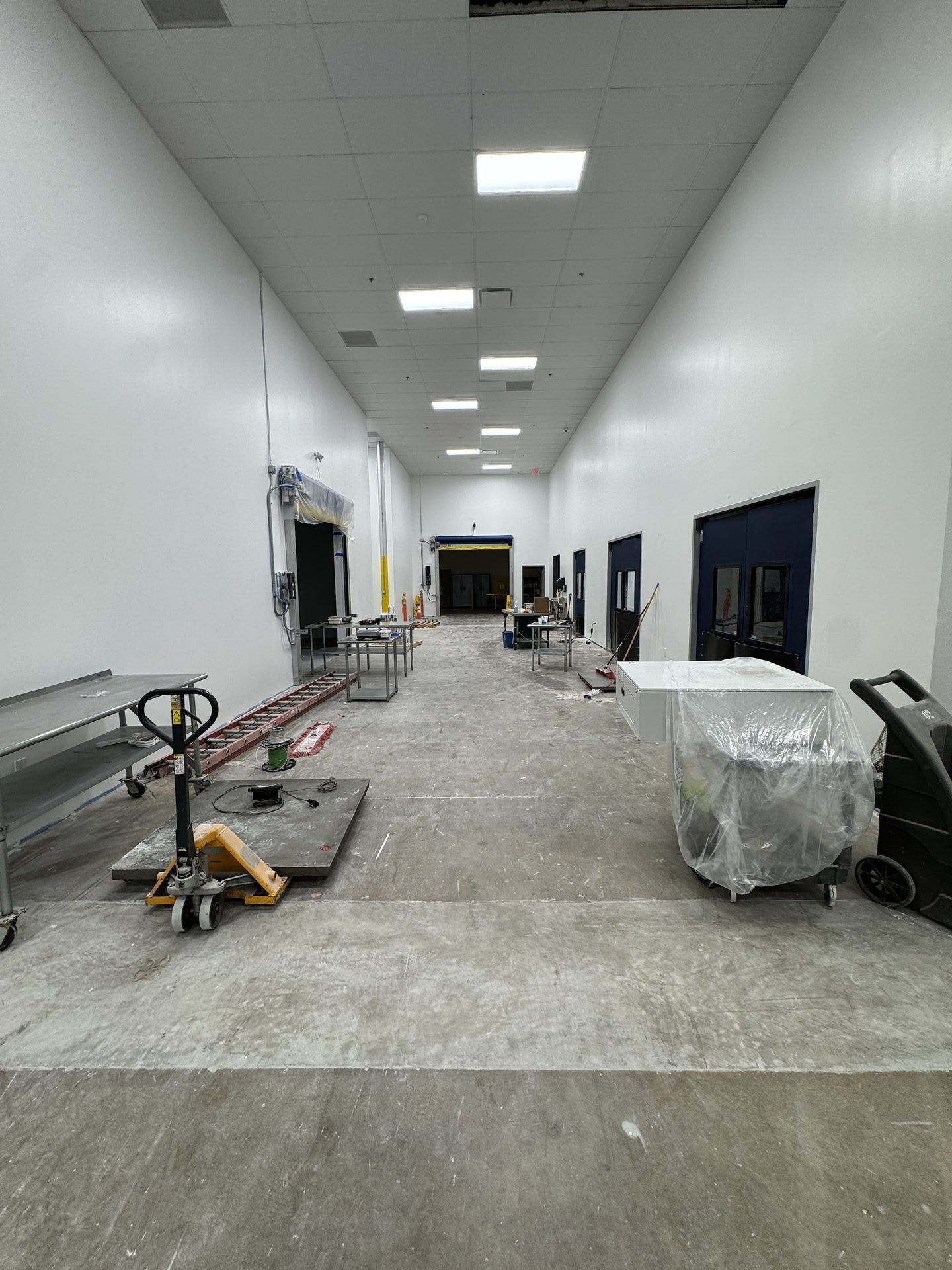 Damaged 40-year-old concrete in pharmaceutical manufacturing space prior to grinding and polishing