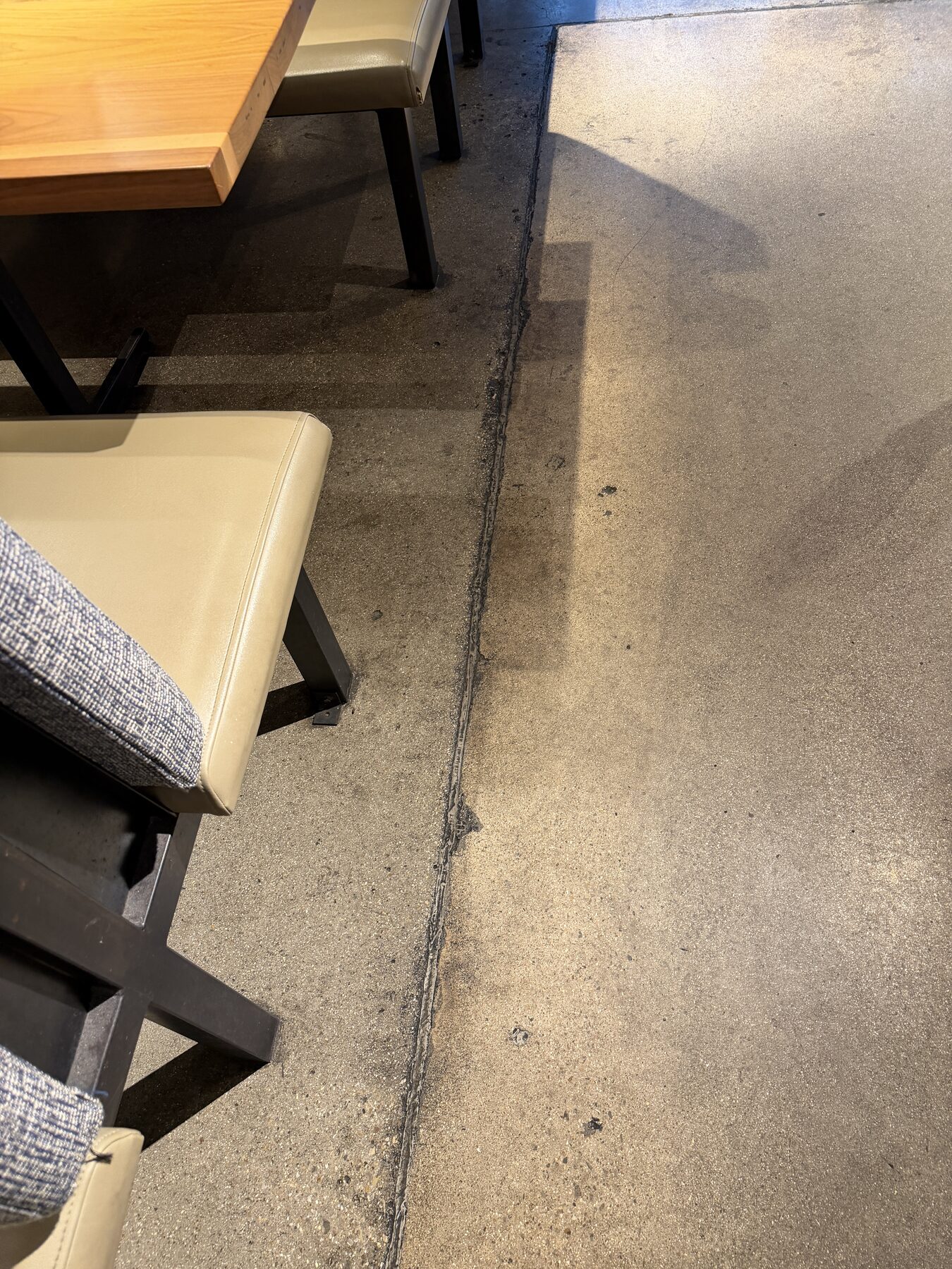Restaurant concrete with dark stains and worn-off sealant before treatment