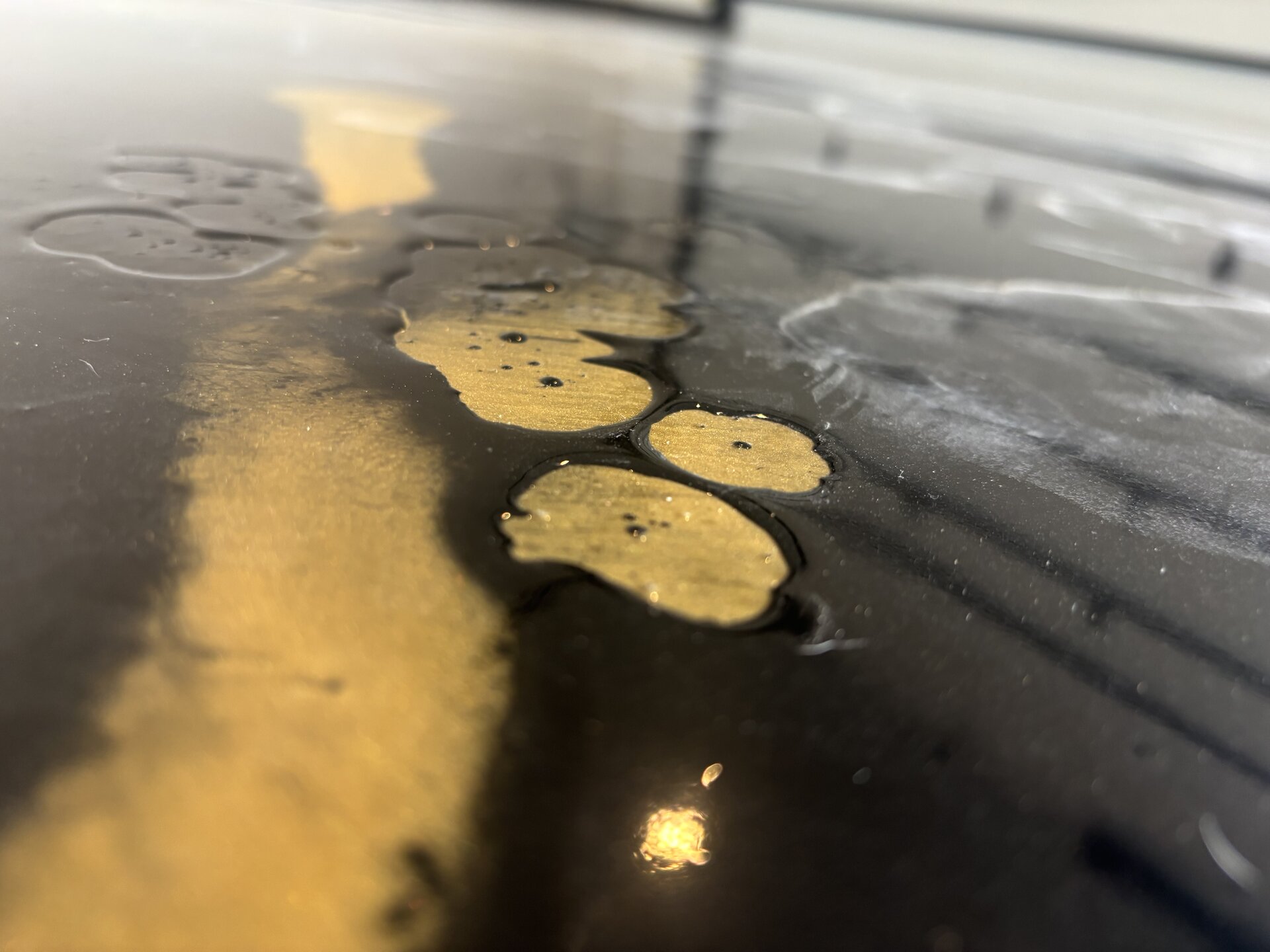 Cheap residential epoxy floor failure showing delamination from concrete slab in Argyle TX home garage