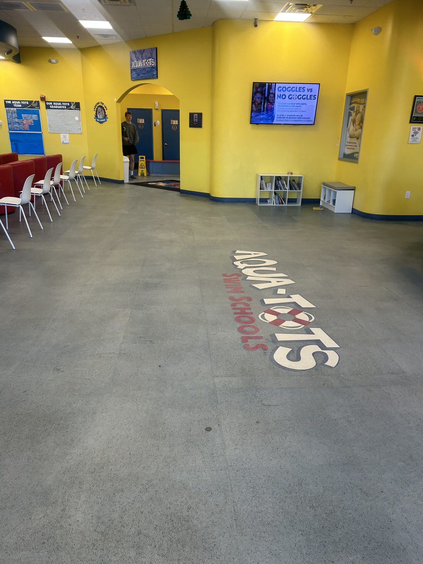 Wet, contaminated VCT seams in swim school before Legacy Industrial Coatings remediation and flake floor system