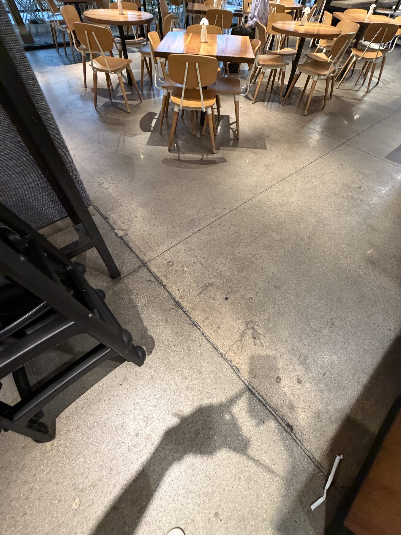 Eight-year-old failed concrete sealant in fast-casual restaurant before resealing
