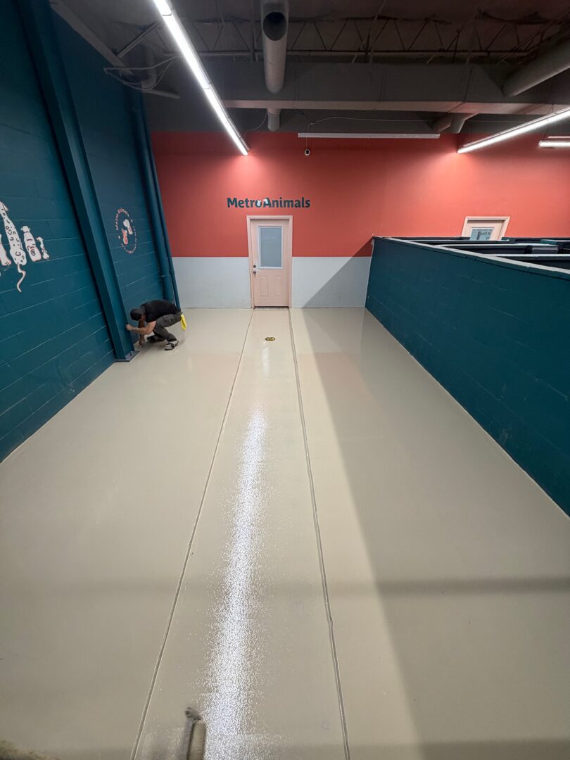 Removing 1.5 inch concrete overlay and original tile down to the structural slab in Plano TX dog facility