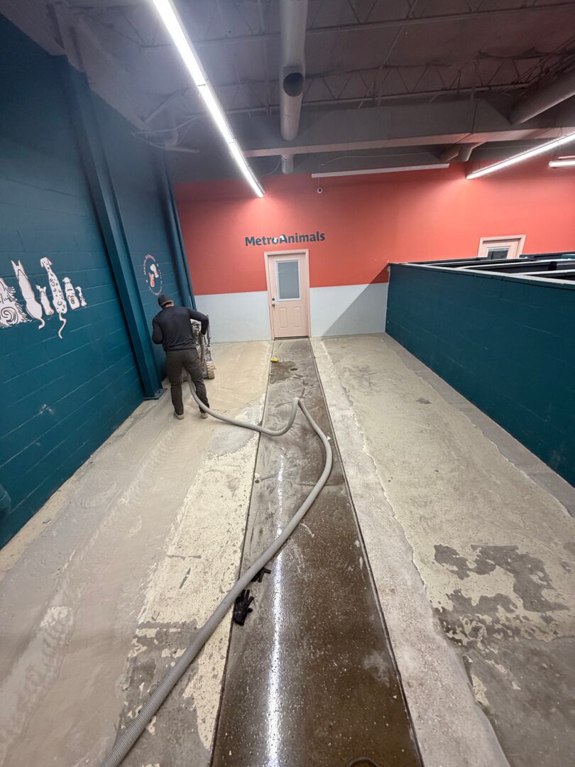 Exposed original concrete slab after full tear-out, prior to grinding and polyurea repairs