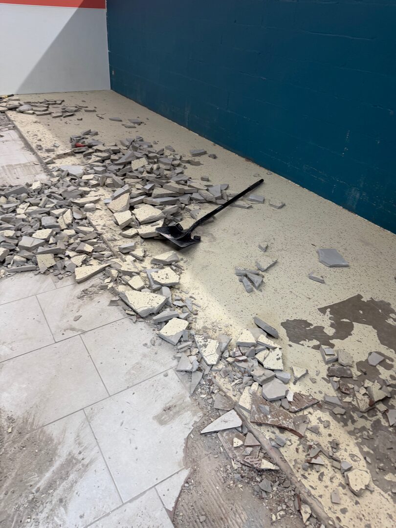 Slab repair and prep work in progress before flake floor broadcast installation