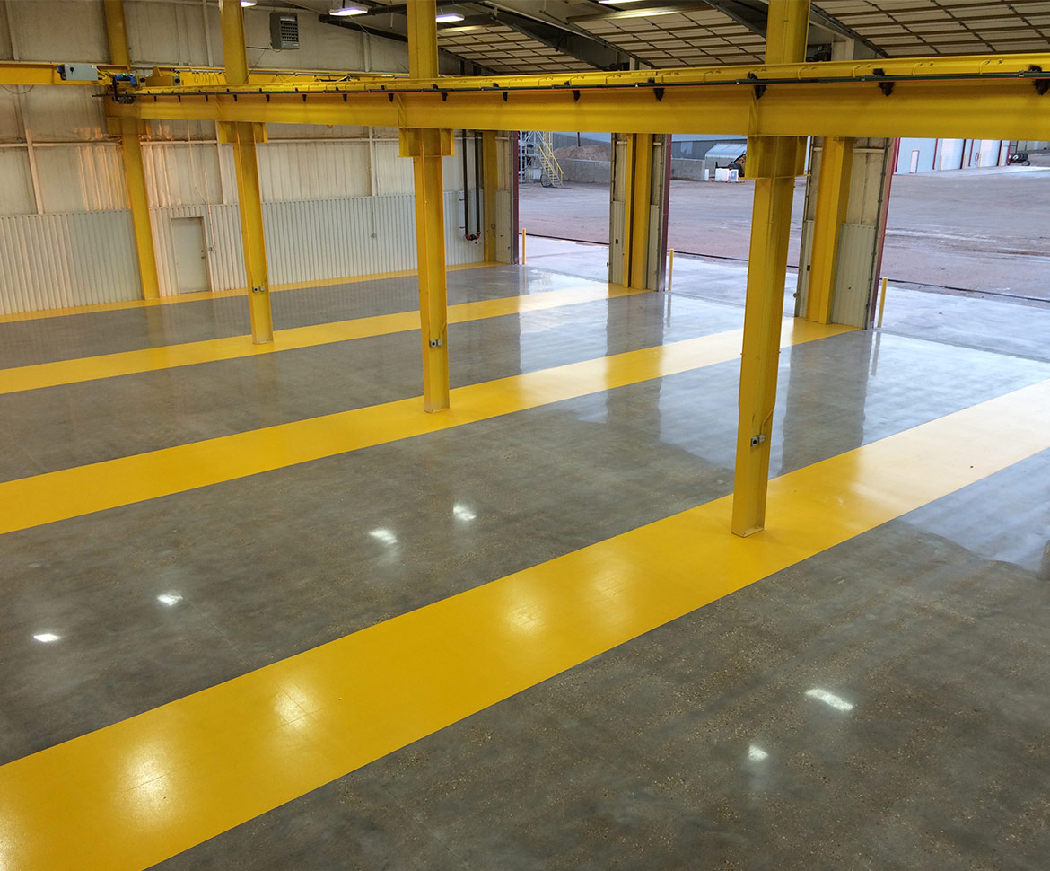 Industrial warehouse polished concrete with yellow safety markings