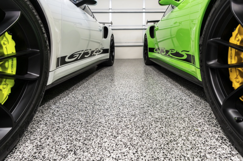 Sports cars on high-end residential garage floor — Addison, TX