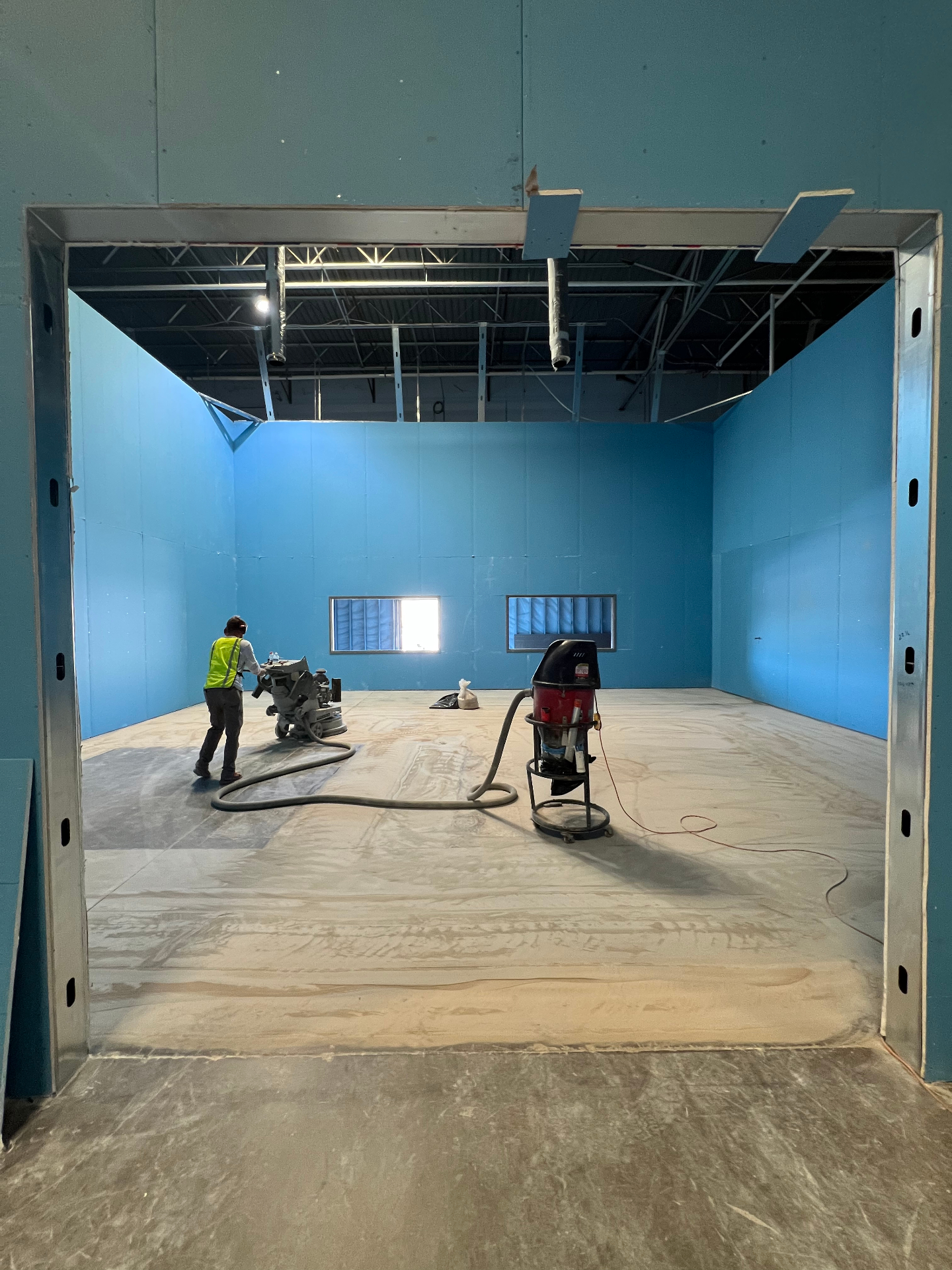 Legacy team working on large commercial floor coating project with professional results